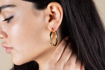 Jewelry, earrings in a beautiful girl's ear, women's accessories, gold earrings, earrings with...