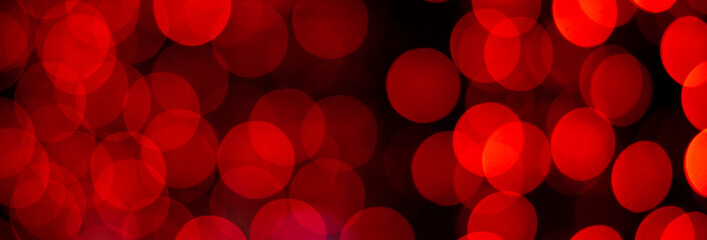 Bright festive red bokeh. Christmas red background. Banner.