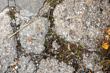 Background image of a fragment of an old road with cracked asphalt