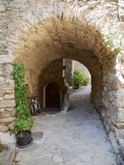 Fototapeta na wymiar Passage into courtyard in Lama, a dreamy hilltop town nestled in the mountains. Corsica, France.