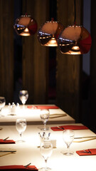 Restaurant interior impressions with lights in a dark-lid room in Berlin, Germany.