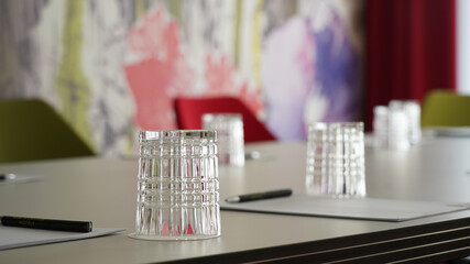 Business meeting room with wine and water glasses in a hotel in Berlin, Germany.