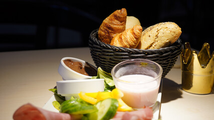 Breakfast with bread and yogurt served in a dark-lid restaurant in Berlin, Germany.