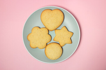 Homemade shortbread cookies on a pink background. Delicious and light dessert. Cookies on a plate.