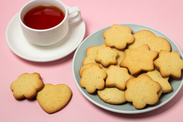 Homemade shortbread cookies on a pink background. Delicious and light dessert. Cookies on a plate.