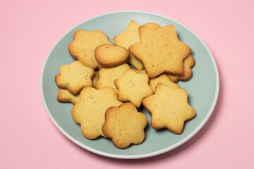 Homemade shortbread cookies on a pink background. Delicious and light dessert. Cookies on a plate.