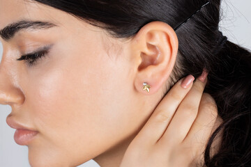 Jewelry, earrings in a beautiful girl's ear, women's accessories, gold earrings, earrings with...