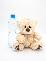 Teddy bear with water in plastic bottle - children soft toy on white background