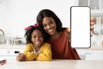 Mobile Ad. Smiling Black Mom And Daghter Showing Big Blank Smartphone