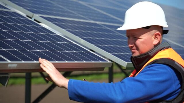Solar Panel Installation Process. Technician Worker With Electric Wrench At A Power Plant