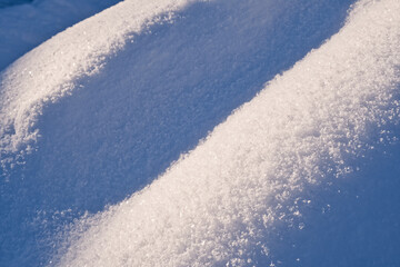 Snow surface texture in light blue tone. Winter season background.