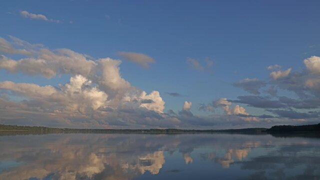 timelapse video with clouds moving above water. landscape with lake and clouds reflection