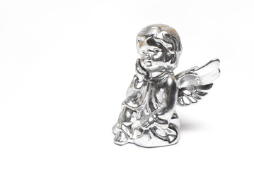 Closeup silver angel cast clay white background