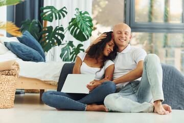 Fototapeta premium Happy weekend. Cheerful couple is together indoors