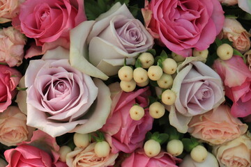 Pink and purple roses in a wedding centerpiece