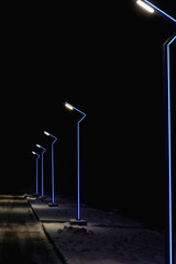 Modern lamppost with blue illumination. Street light. A modern looking street lamp post
