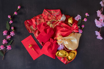 Chinese new year festival decorations pow or red packet, orange and gold ingots or golden lump on a...