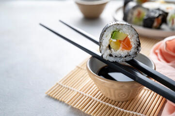 Sushi rolls close up with salmon, avocado and cucumber.