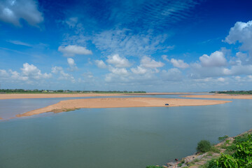 Beautiful landscape image of Mahanadi river of Odisha, with blue sky and white clouds in the background. Nature stock image of Odisha with copy space.