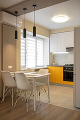 Part of the interior of the living room with a wardrobe and kitchen apartment interior, kitchen in yellow tones