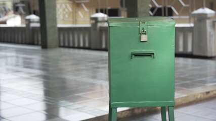 Green charity box on a Masjid or Mosque for people to donate money after pray to help others