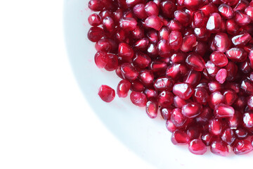 red healthy pomegranate on white dish