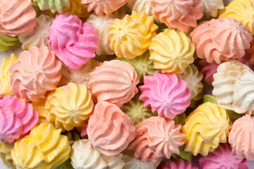 meringue cookies, also known as kisses, colorful, light, crunchy sweet snack, closeup view taken from above, food background