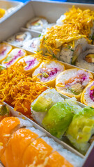 Large sushi set on black. An assortment of various maki, nigiri and rolls. Close up.