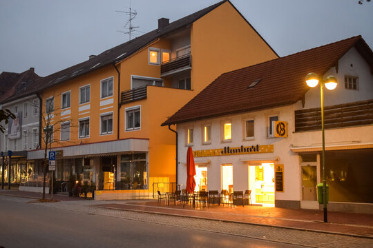 BUCHLOE, GERMANY - OKTOBER 09, 2018: Light from a cafe on an empty street in the morning in Buchloe Germany