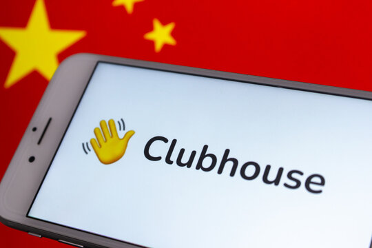 Kumamoto, JAPAN - Feb 15 2021 : Concept image Clubhouse app on iPhone screen with Chinese flag background. Clubhouse app reportedly banned in China in Feb 2021