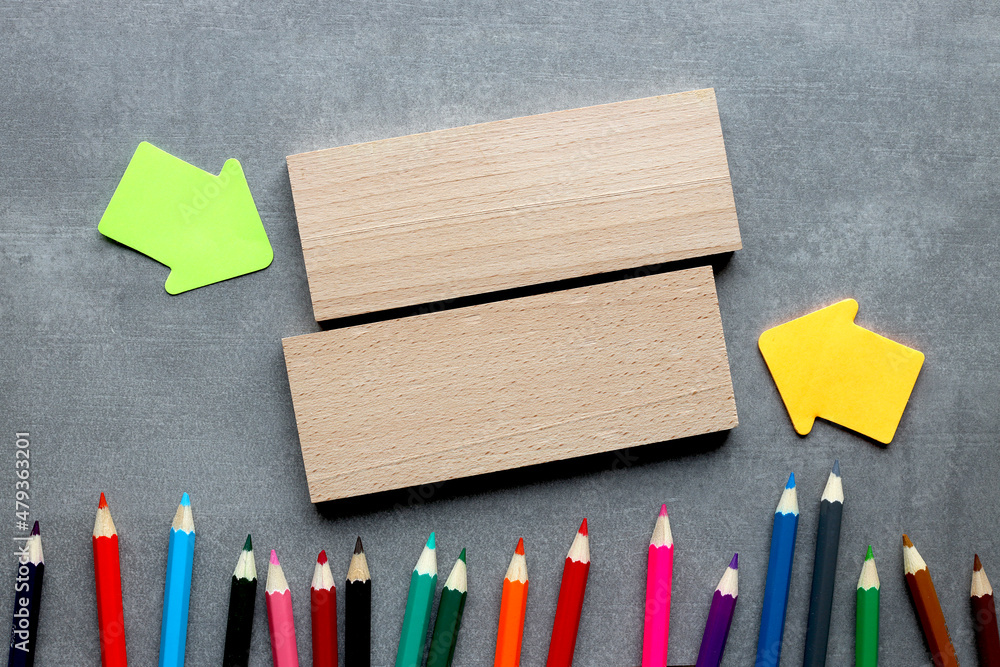 Aufkleber flat lay of wooden blocks on gray background with multicolored pencils with copy space. financial or