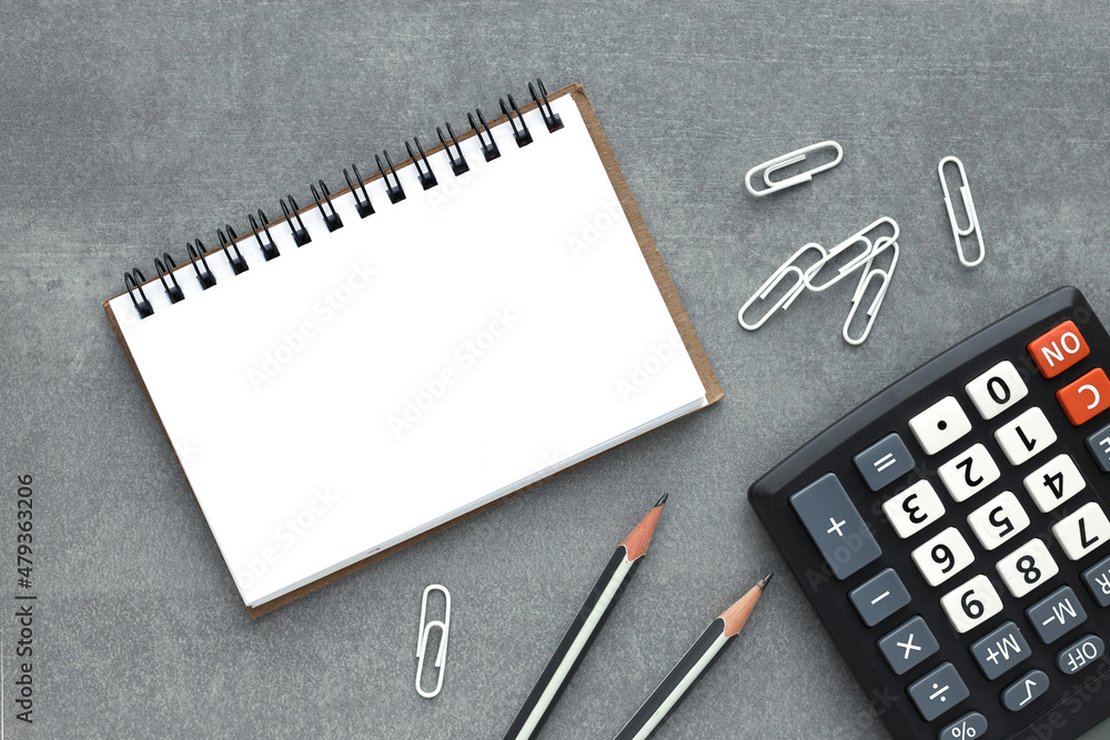 Poster calculator and brown open notepad with blank notepad. flat lay business concept.