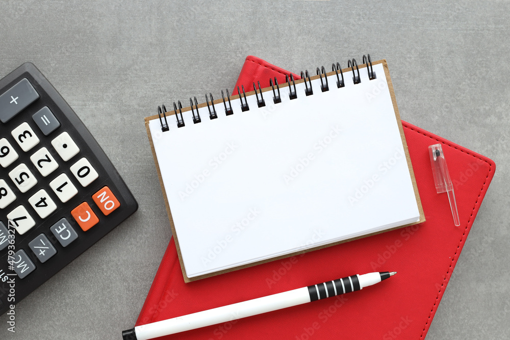 Aufkleber blank notebook with a pen on a white wooden table. red notepad and open notepad business concept