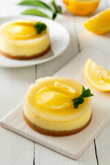 Cheesecake lemon tart cake or pie, with fresh lemon and mint. White background, lifestyle healthy desert.