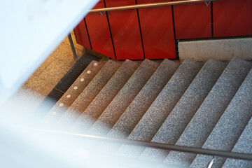 Steps lead down to the tram station. People empty space in the city. High angle view.