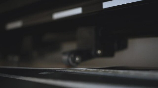 Industrial plotter for cuttering paper in print shop. Modern commercial equipment in work, professional factory 