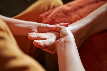 Close-up of hands massaging feet