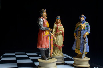 Fototapeta na wymiar chess pieces on board on black background