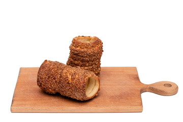 trdelnik on a wooden board on a white background