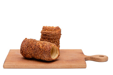 trdelnik on a wooden board on a white background