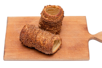trdelnik on a wooden board on a white background