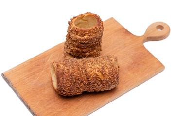 trdelnik on a wooden board on a white background