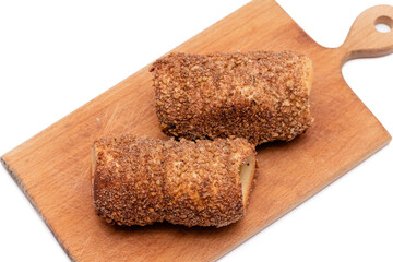 trdelnik on a wooden board on a white background