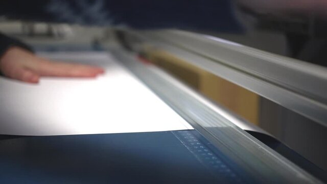 Hand paper cutter machine in print shop. Industrial equipment video