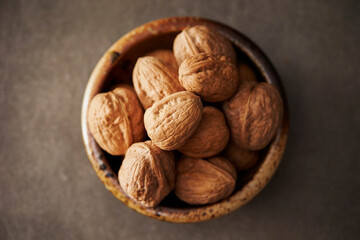 Walnuts in a bowl on a dark background