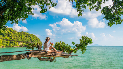 Traveler woman on tree branch joy nature view scenic landscape Railay beach Krabi, Adventure...