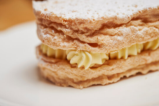 Dacquoise on a plate, cream in cookies