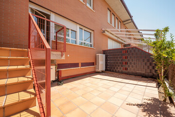terrace of single family house with clay tile floor and metal railing