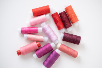 Sewing machine threads in red colors. Flat lay, top view