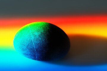 Zen stone in touch of rays of color.
